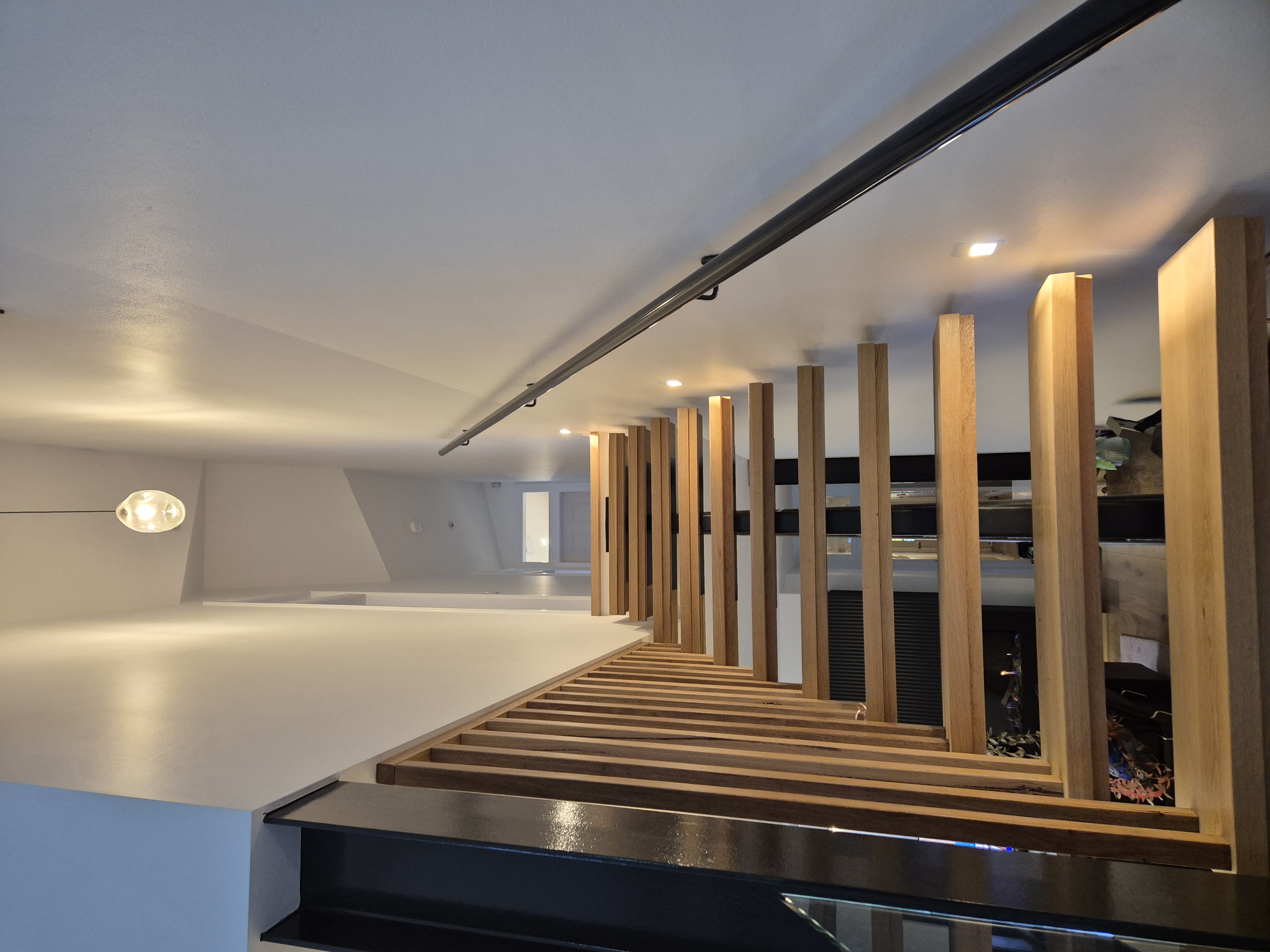 Floating timber staircase with feature pendant light and LED step lighting